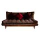 un sofa cama color chocolate con cojines de colores rojos